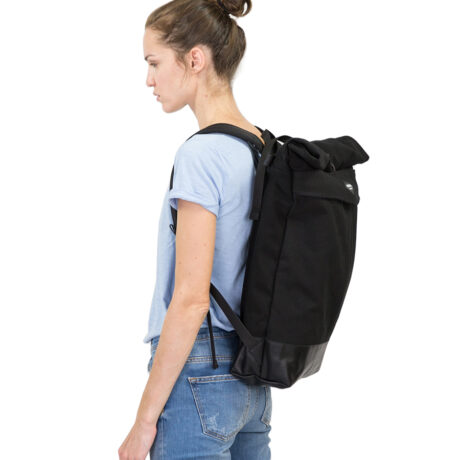 A model wearing Braasis elegant black Levo backpack made from cotton and leather