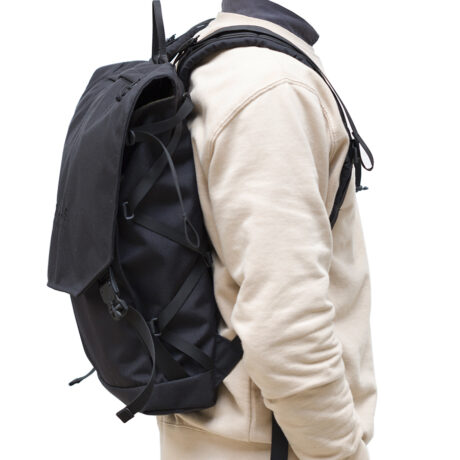 A man wearing the Braasi Klopista, a practical designer backpack great for travel.
